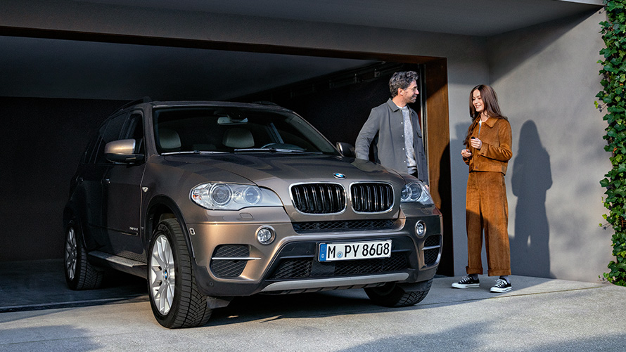 BMW devant un garage avec modèles BMW Value Service BMW devant un garage avec modèles